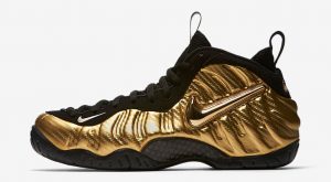 all black foams with gold nike sign