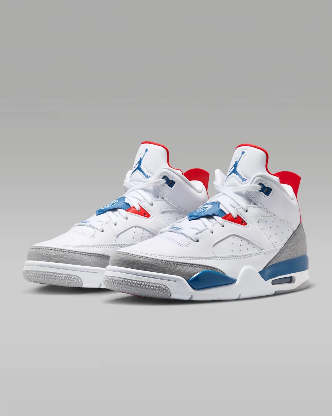 Angled pair of Jordan Son of Mars Low "True Blue" sneakers in White, True Blue, Cement Grey and Varsity Red.