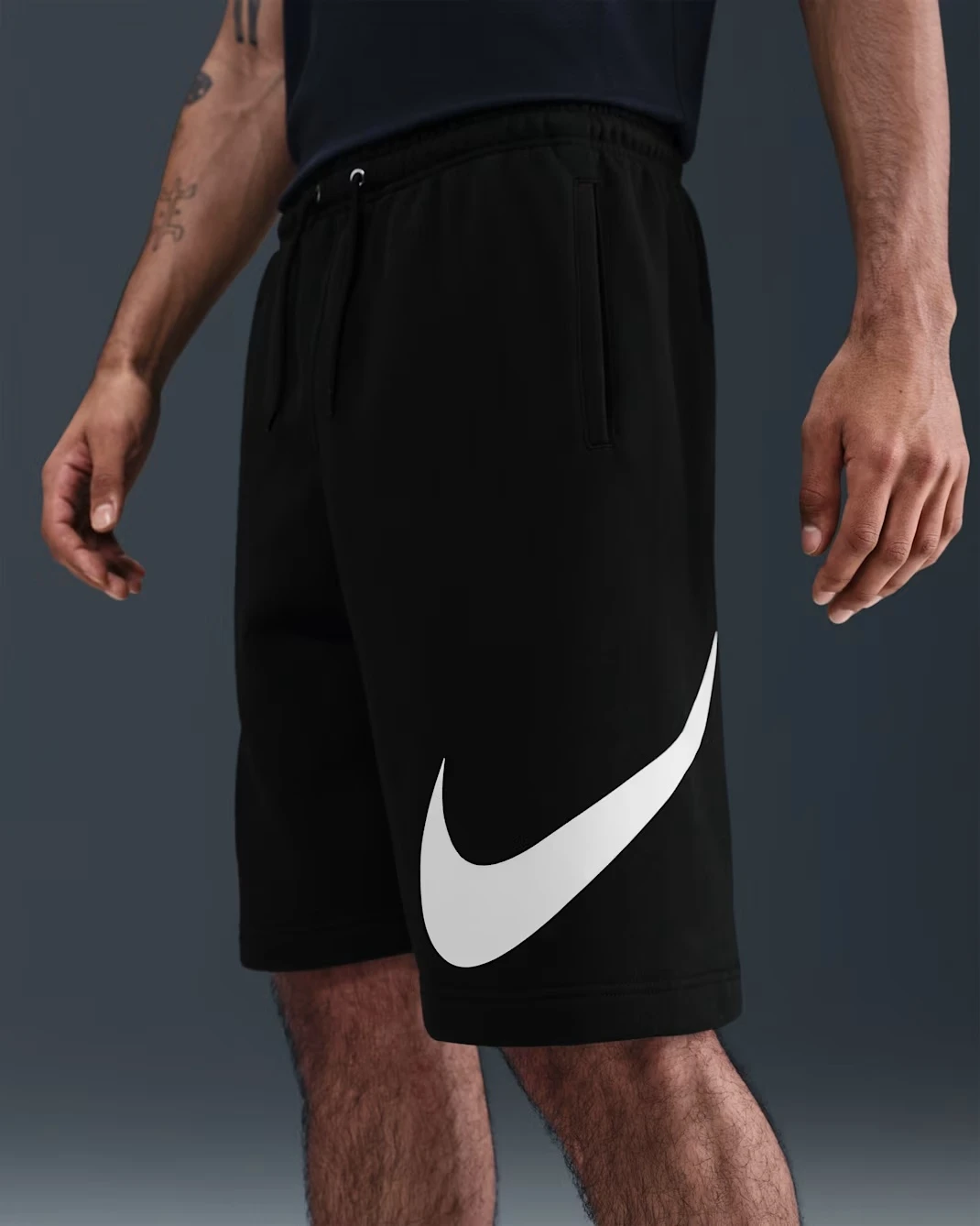 Nike Club fleece shorts in Black with oversized white Swoosh.