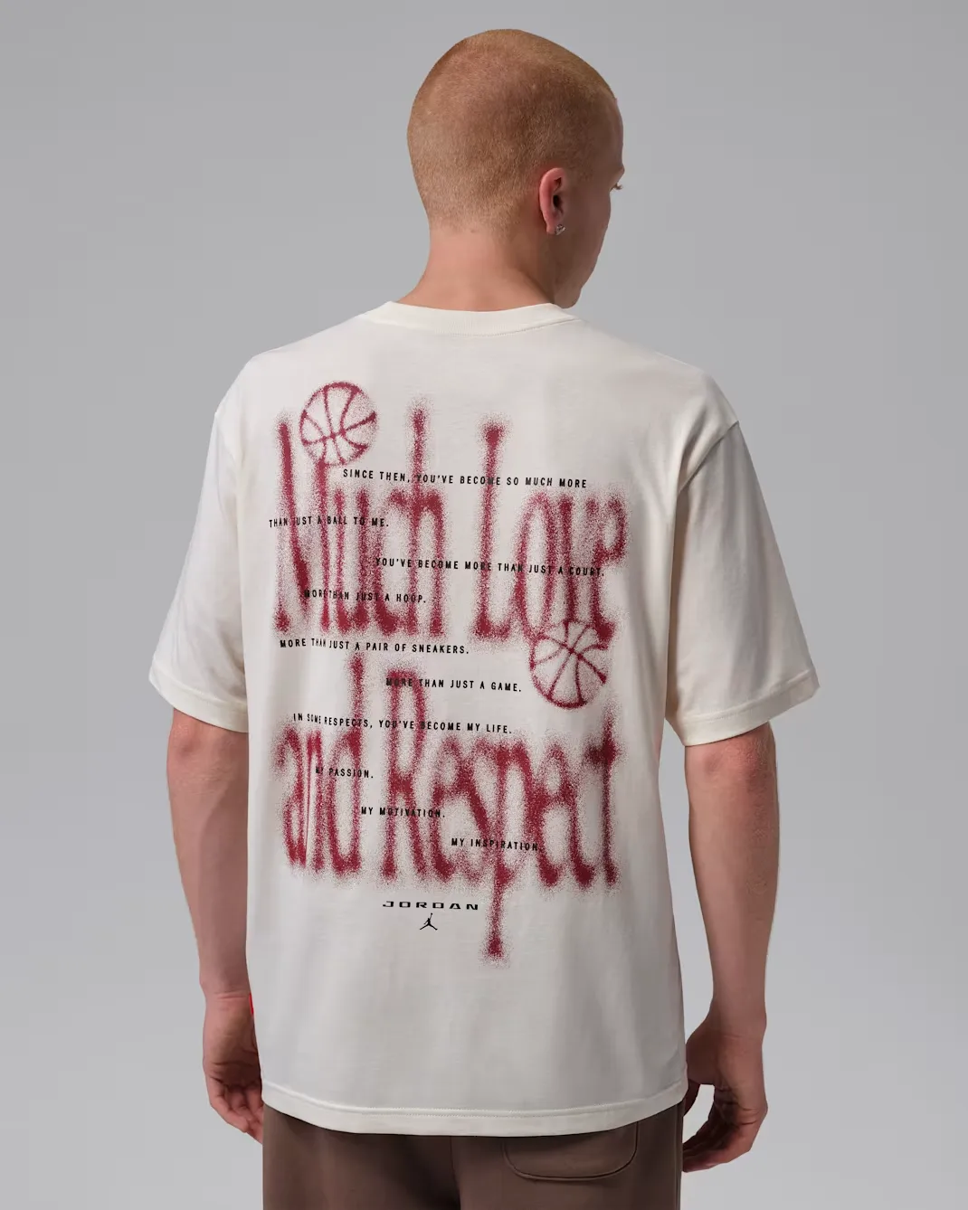 Back view of the Jordan Brooklyn Love Letter T-Shirt in Soft Pearl featuring a large Team Red Love Letter graphic and Jordan branding.