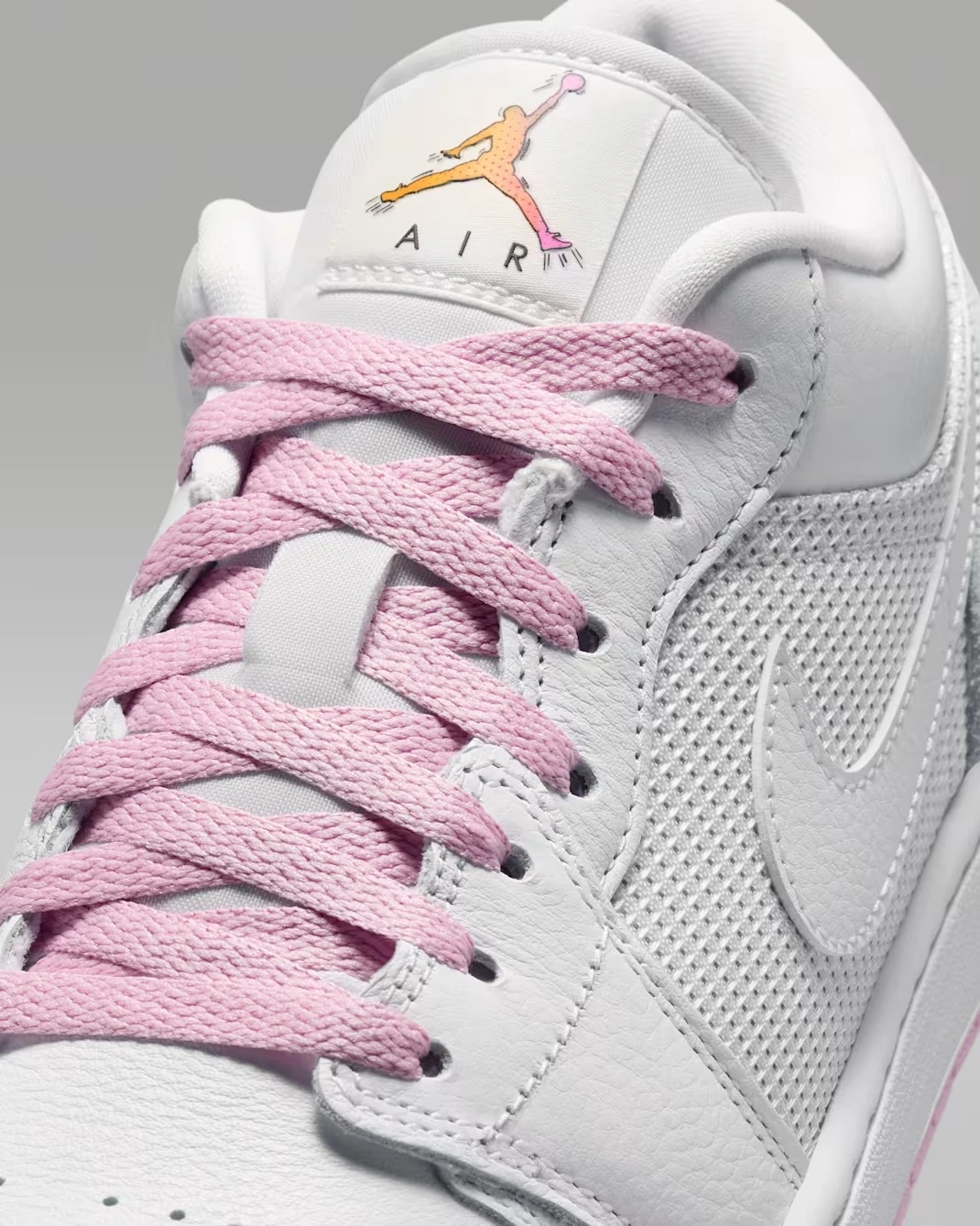 Close-up of the tongue and pink laces on the Air Jordan 1 Low "Comic."