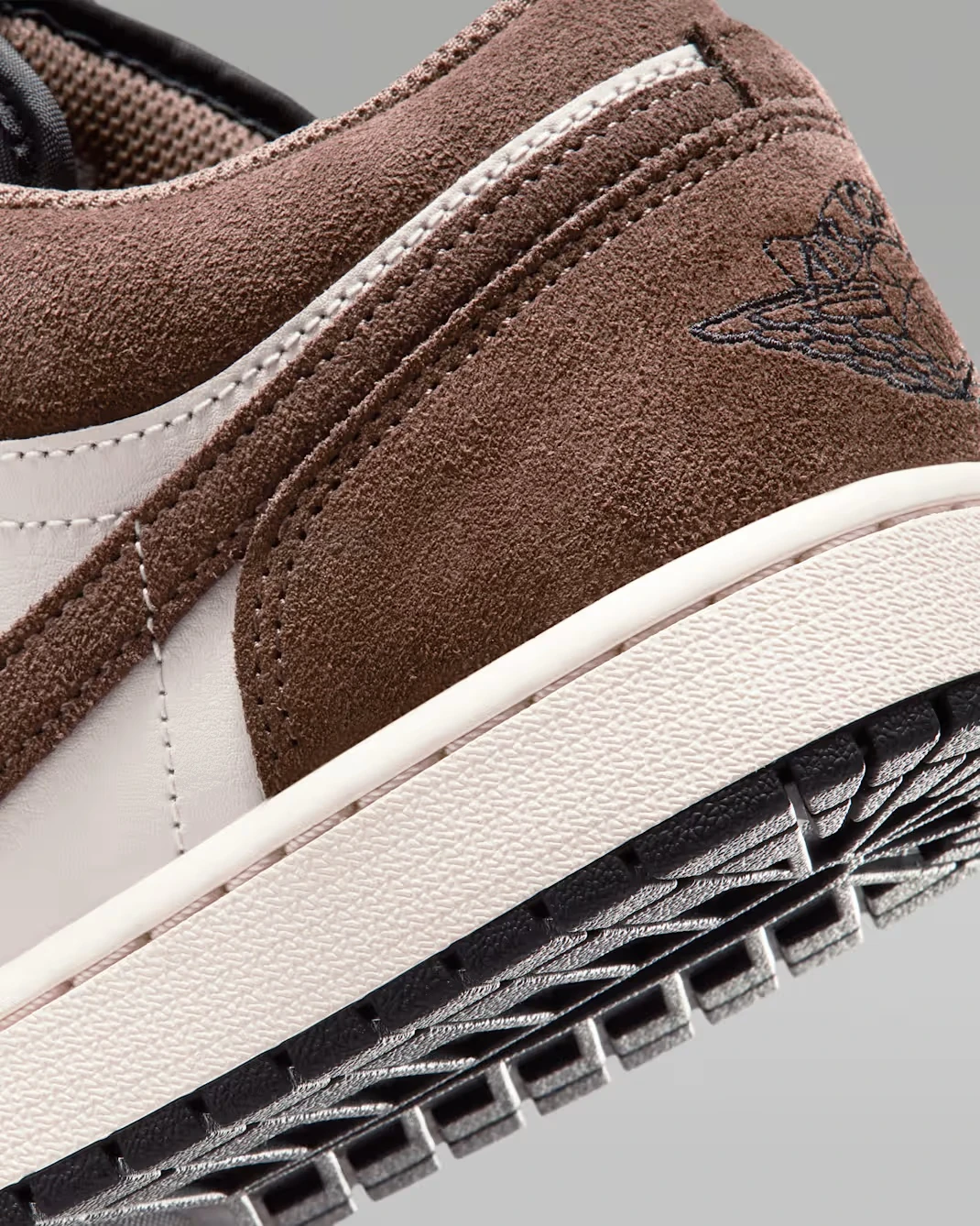 Close-up of the suede heel and embroidered Wings logo on the Air Jordan 1 Low "Palomino/Phantom."
