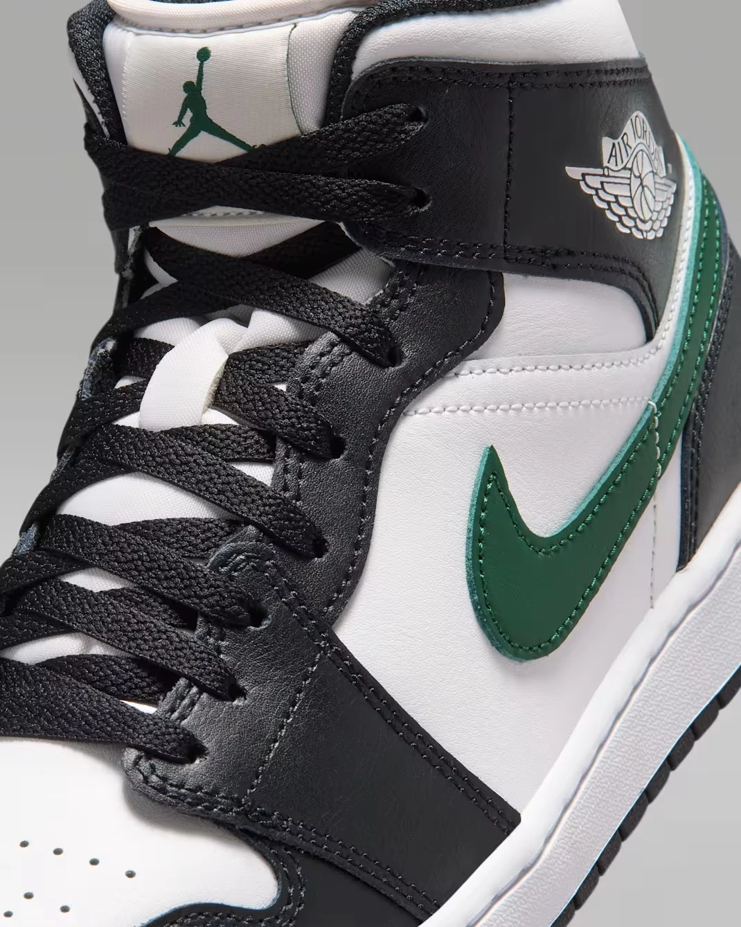 Close-up of the Gorge Green Swoosh on the Air Jordan 1 Mid "Black/Gorge Green."