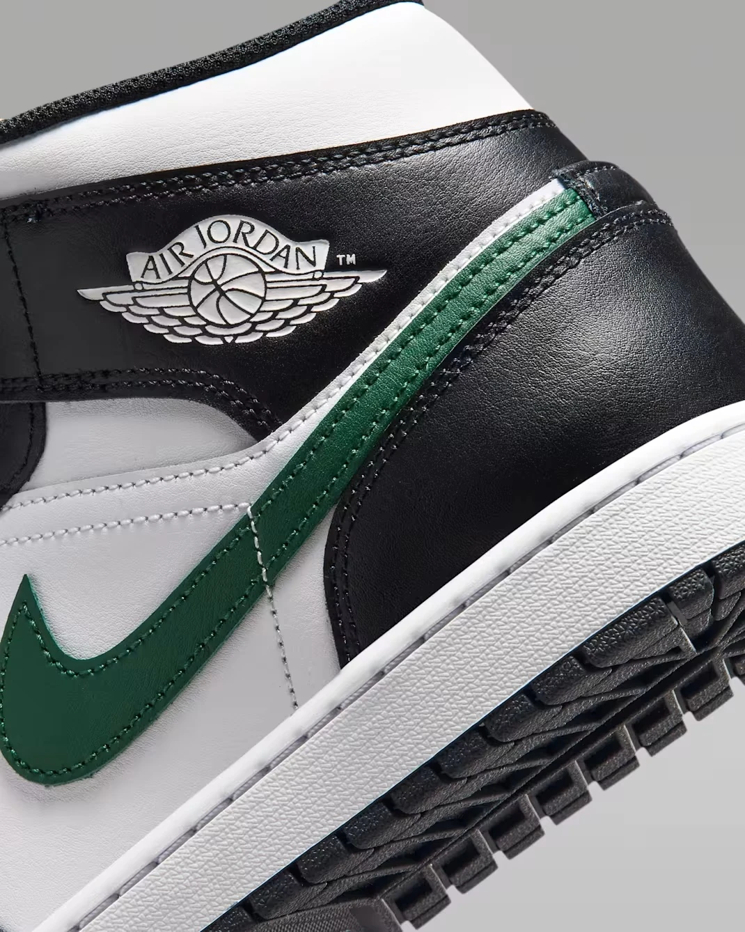 Close-up of the Air Jordan Wings logo on the Air Jordan 1 Mid "Black/Gorge Green."