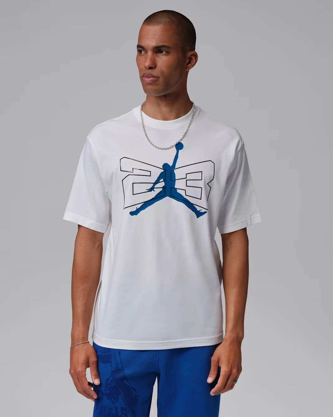 Front view of the Jordan 23 Graphic T-Shirt in White and Game Royal, matching the Air Jordan 13 Flint (2026) sneakers.