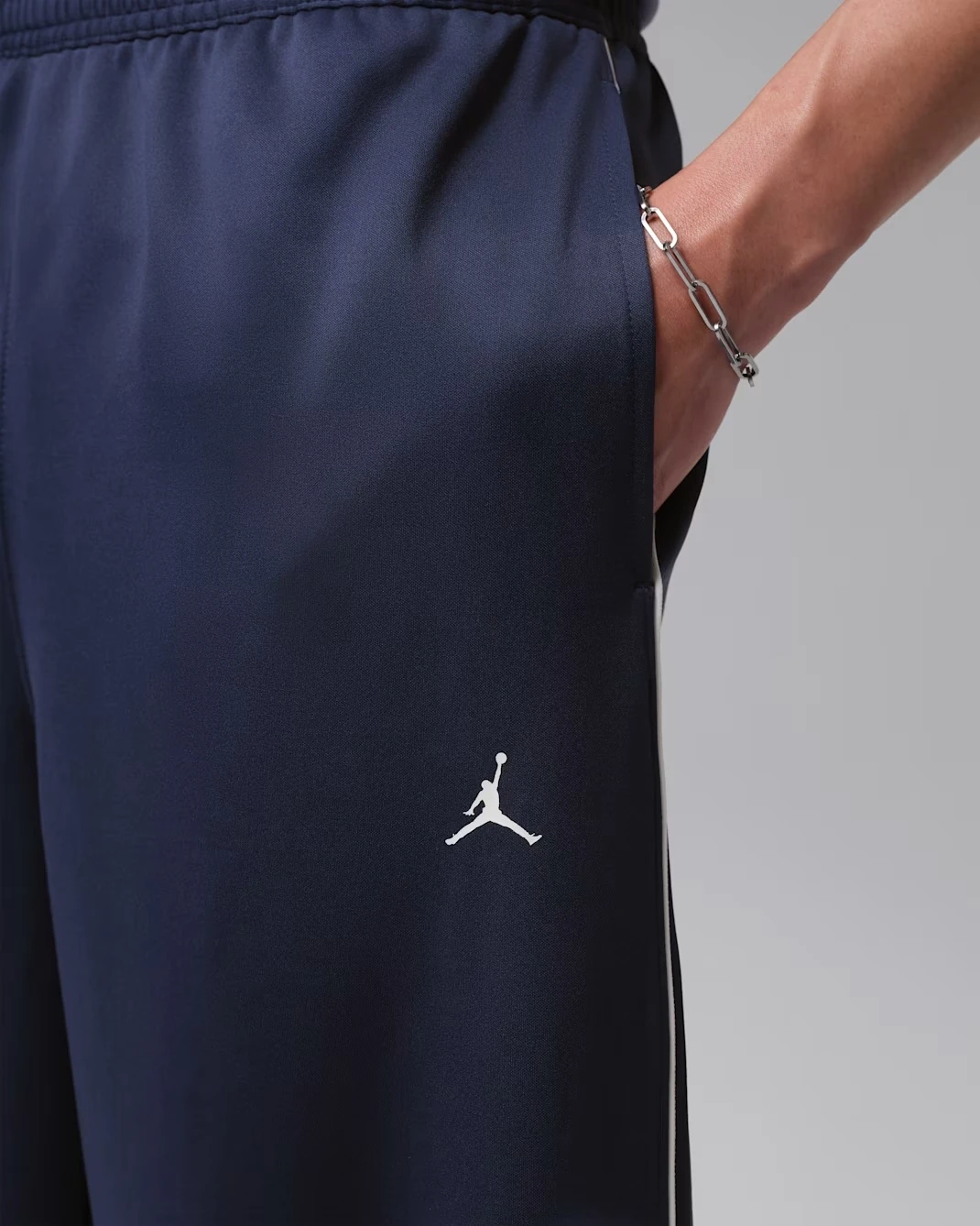 Detail view of the Jordan Track Pants in Midnight Navy matching the Air Jordan 13 Flint (2026).