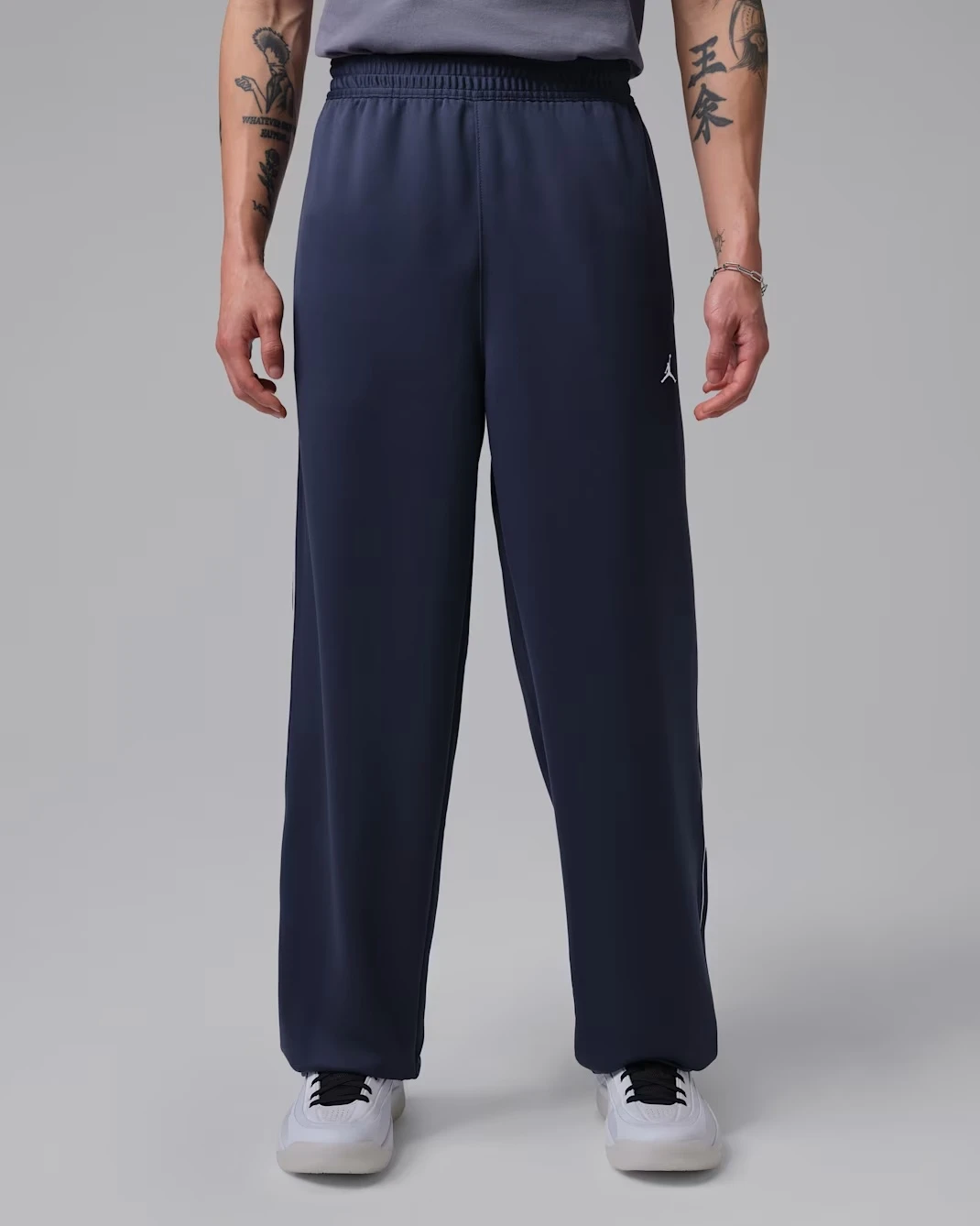 Front view of the Jordan Track Pants in Midnight Navy matching the Air Jordan 13 Flint (2026).
