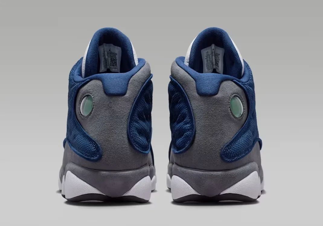 Heel view of the Air Jordan 13 Flint (2026) in Navy, University Blue, Flint Grey, and White.