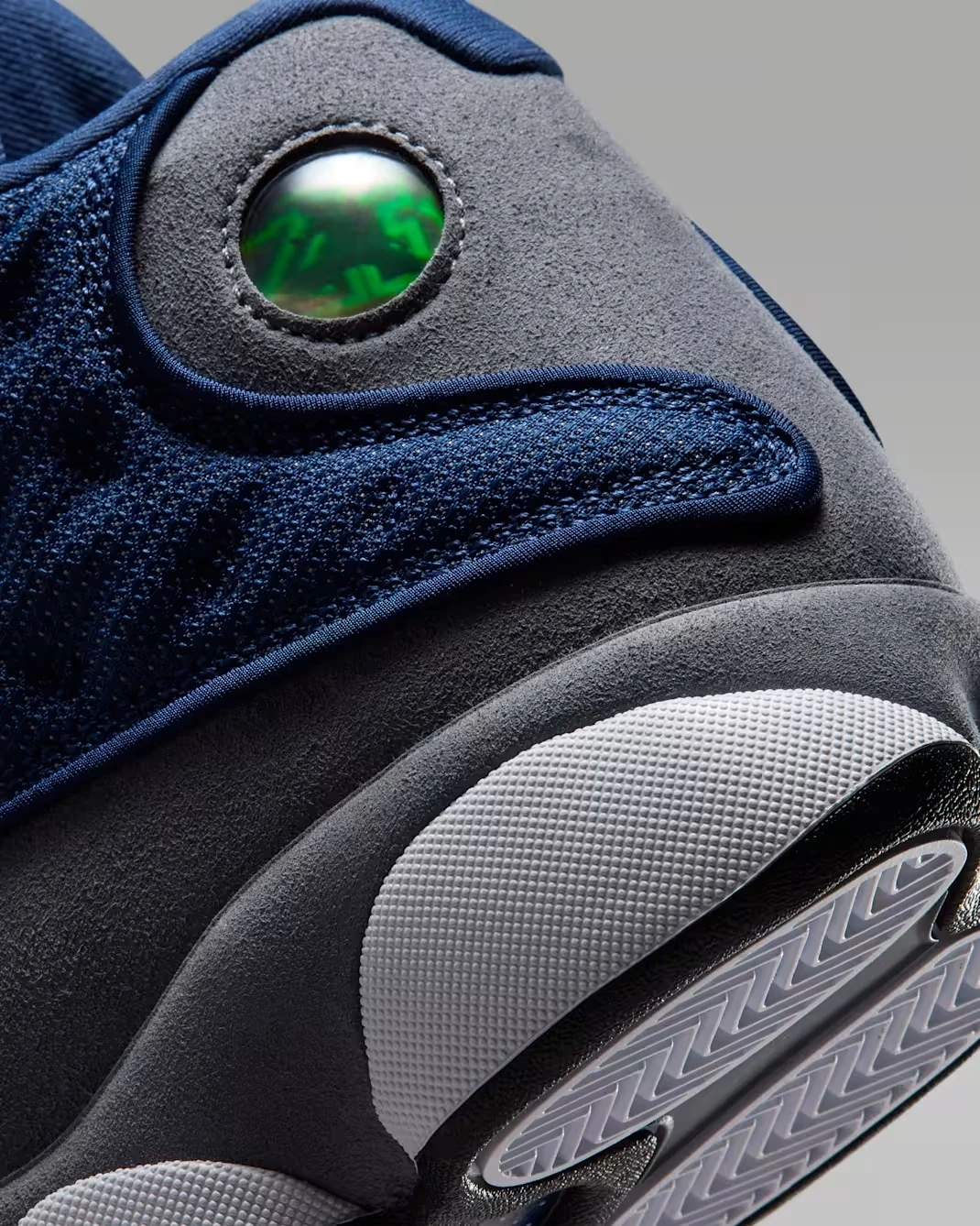 Close-up of the hologram heel detail on the Air Jordan 13 Flint (2026) in Navy, University Blue, Flint Grey, and White.