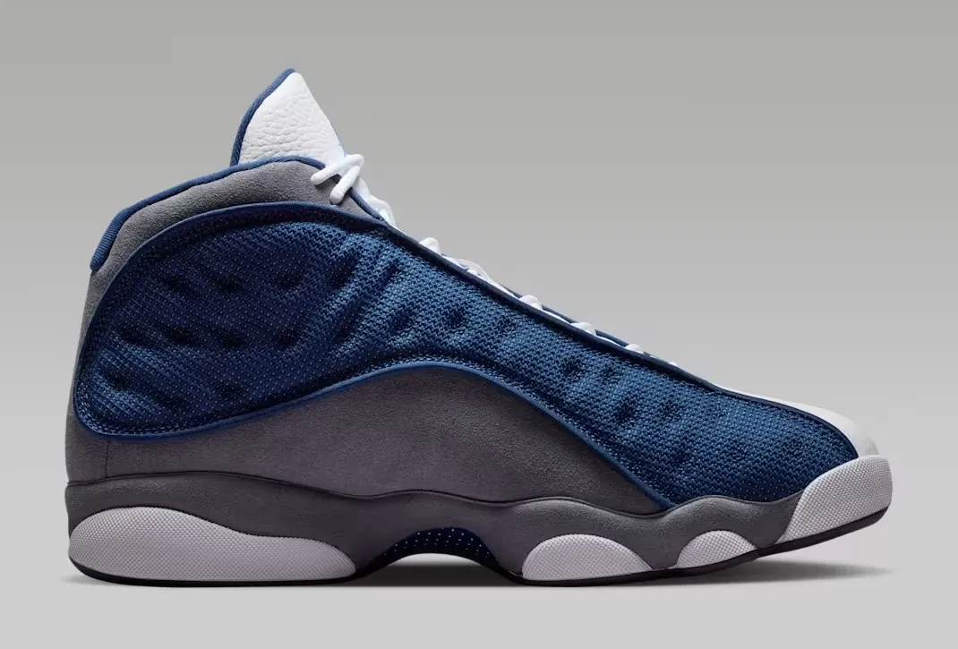 Lateral side view of the Air Jordan 13 Flint (2026) in Navy, University Blue, Flint Grey, and White.