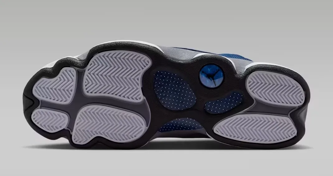 Outsole view of the Air Jordan 13 Flint (2026) in Navy, University Blue, Flint Grey, and White.