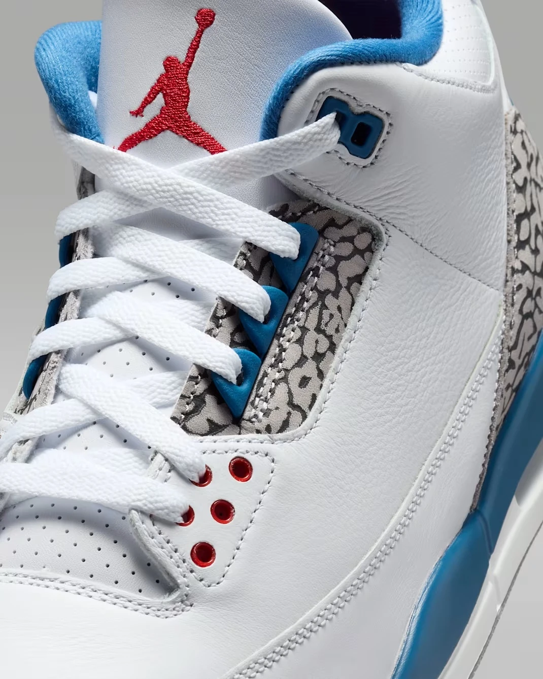 Close-up of the Air Jordan 3 True Blue (2026) showing the laces, tongue and elephant print eyelets.