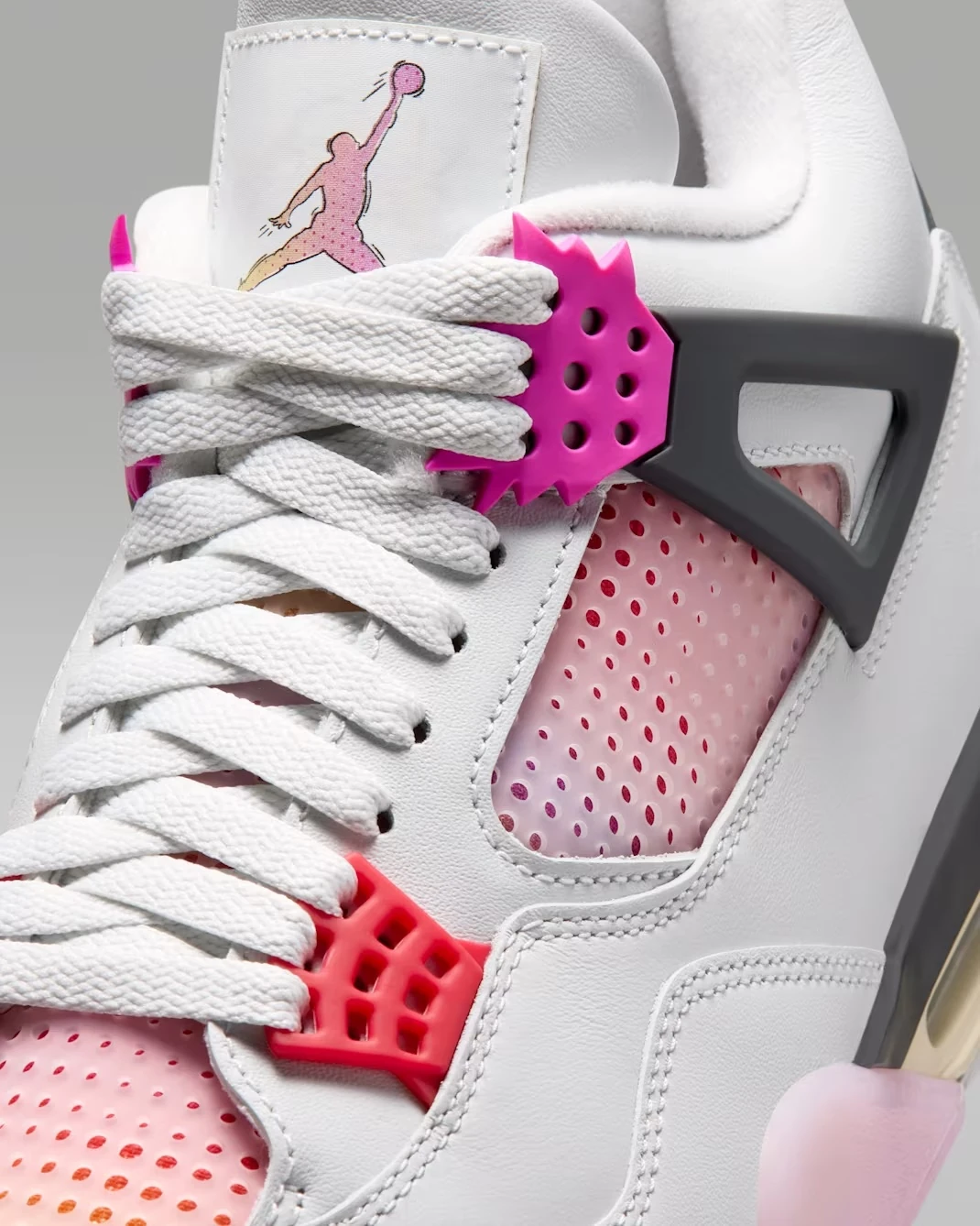 Close-up of the Air Jordan 4 Comic lace wings, tongue logo and gradient mesh panel.