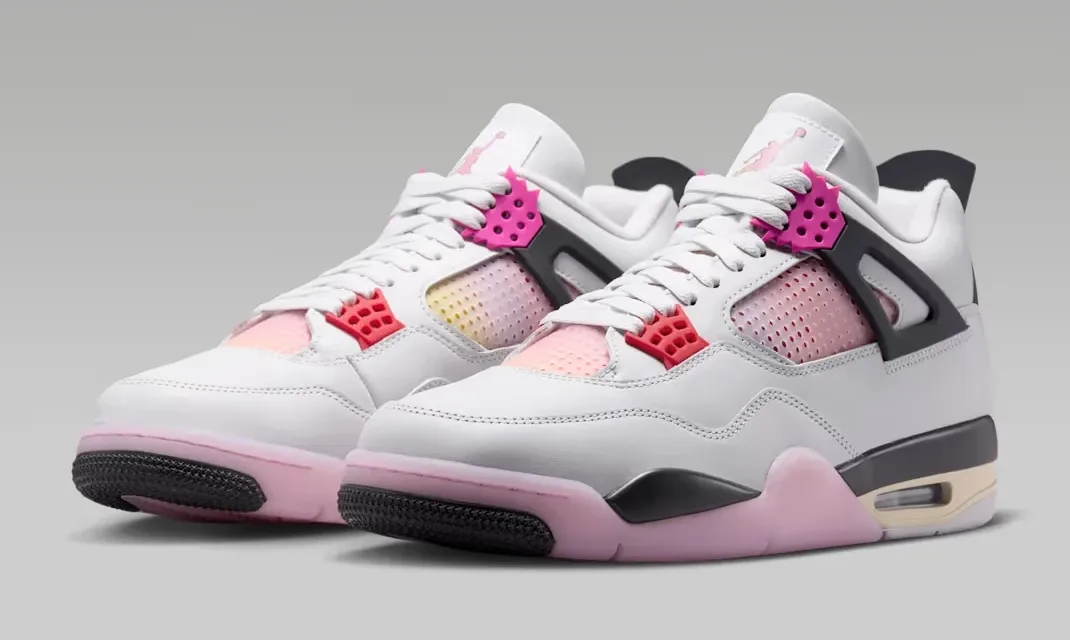 Angled front view of a pair of Air Jordan 4 Comic sneakers in Off White, Anthracite and Fire Pink.