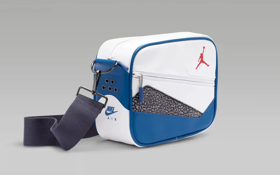 Side view of the Jordan AJ3 True Blue Messenger Bag with Nike Air branding and elephant print.