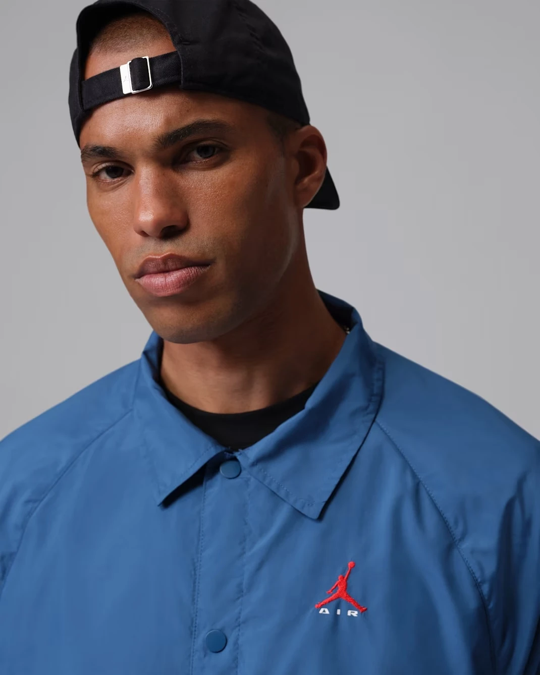 Close-up of the Jordan Brooklyn Coaches Jacket showing the smooth woven fabric and embroidered Jumpman logo.