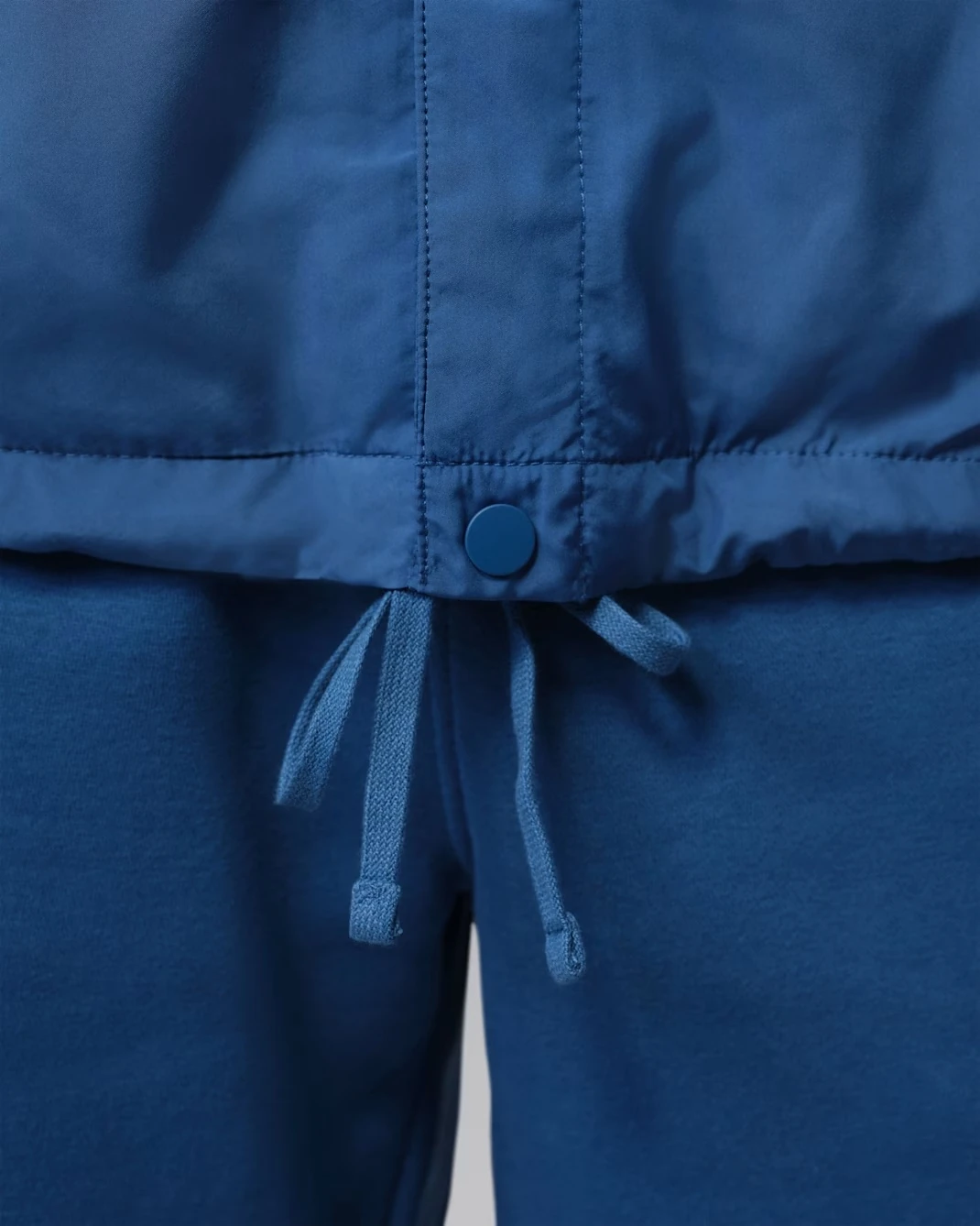 Adjustable drawcord hem detail on the Jordan Brooklyn Coaches Jacket in True Blue.