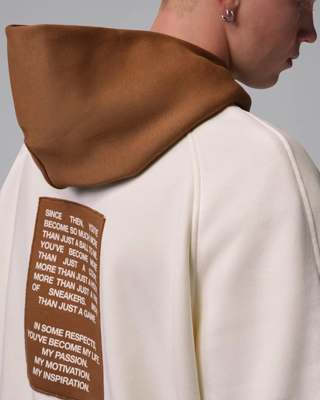 Detail of the Light British Tan hood and MJ tribute back graphic on the Jordan Brooklyn Fleece Hoodie.