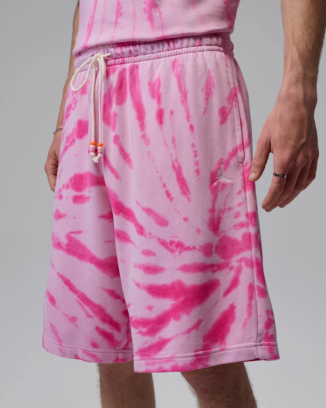 Close-up front detail of Jordan Brooklyn tie-dye fleece shorts in Iced Carmine, Pinksicle and Pale Ivory.