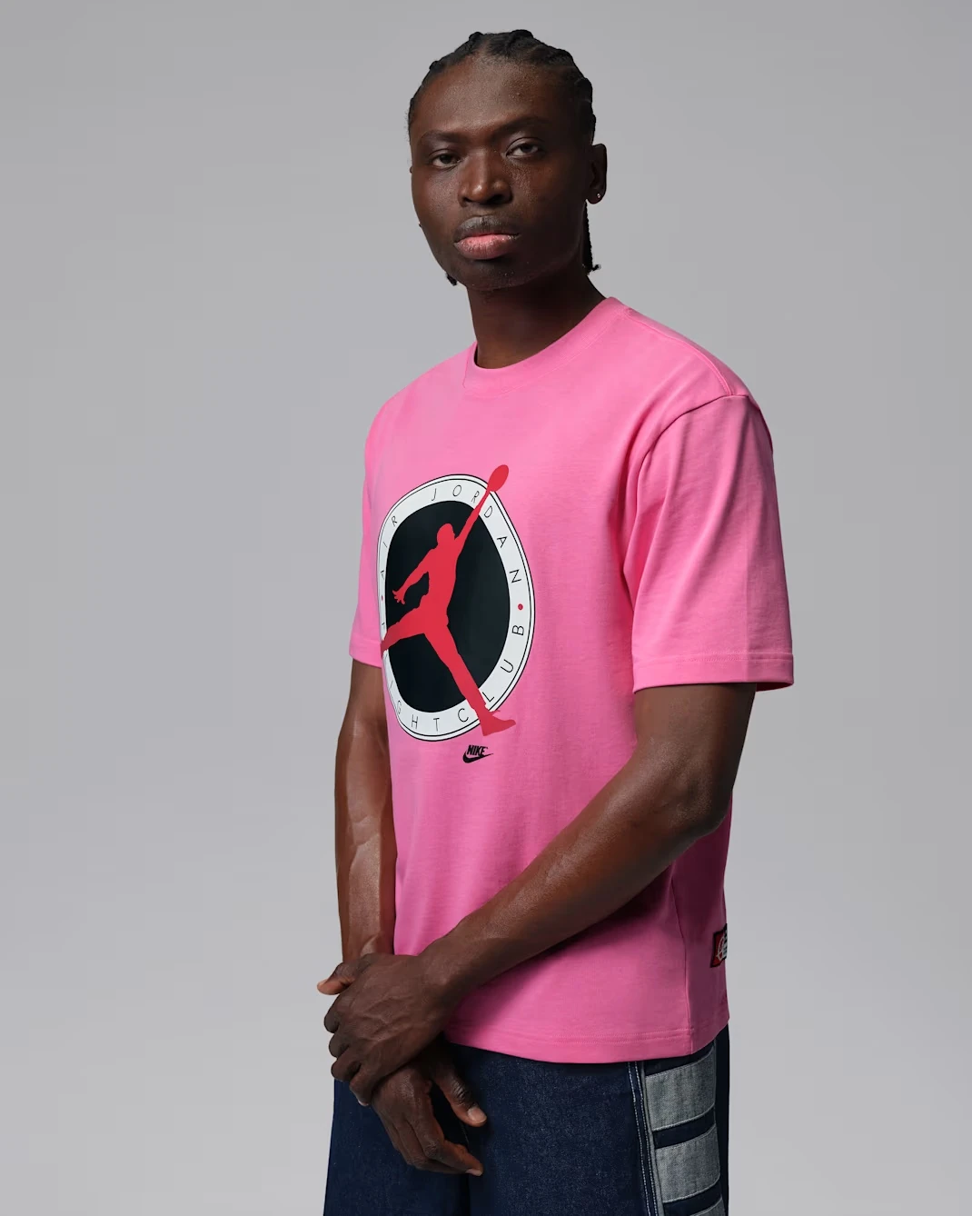 Front view of the Jordan Flight Club T-Shirt in Pinksicle with University Red graphic, matching the Air Jordan 4 "Comic."