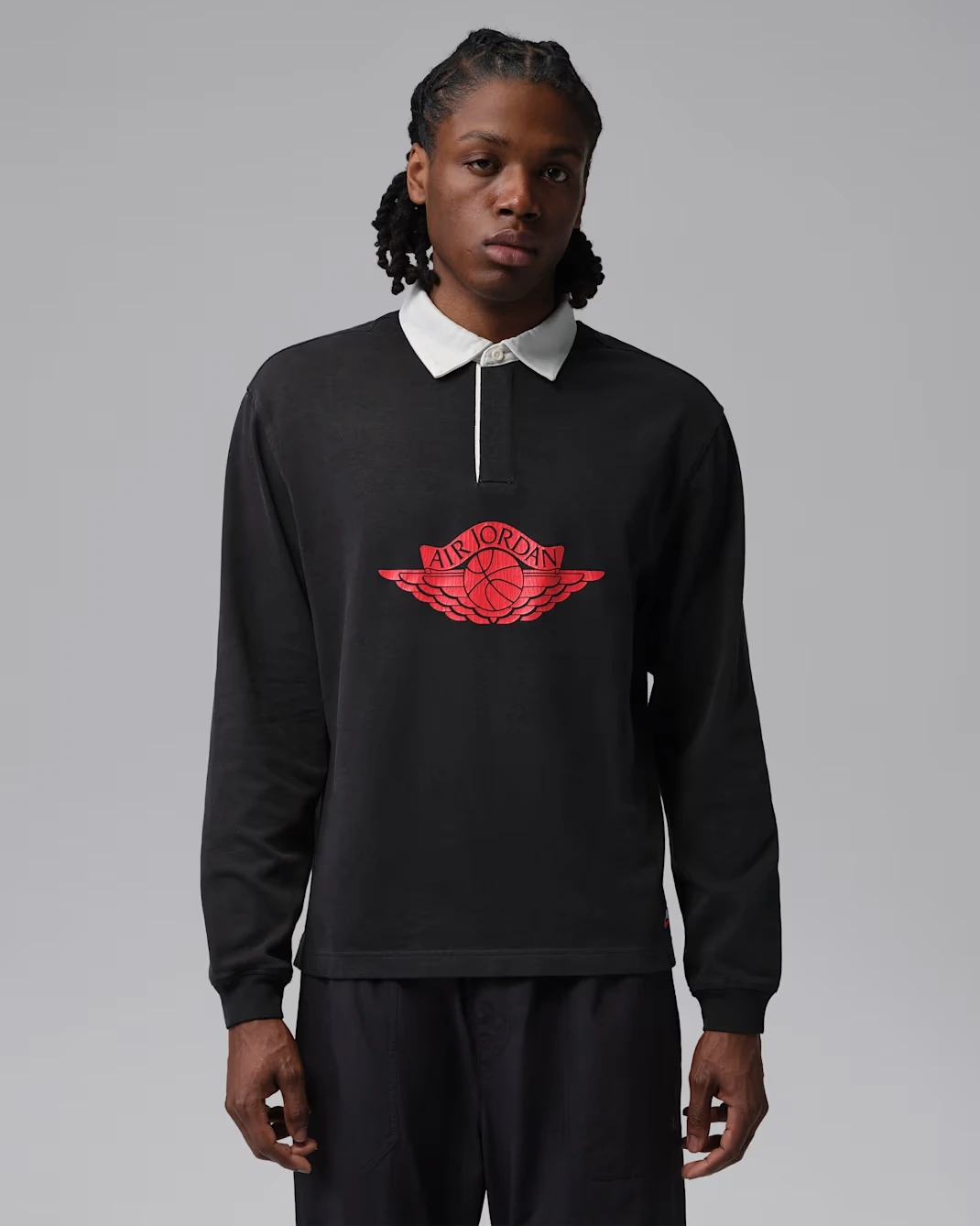 Black Jordan Flight Essentials rugby top to wear with the Air Jordan 1 Mid Black/Palomino.
