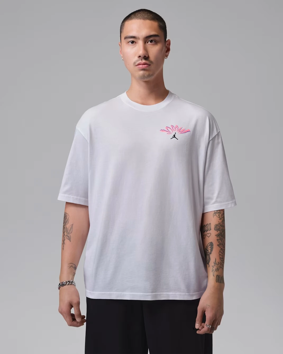Front view of the Jordan Flight T-Shirt in White with black and pink Jumpman graphics.
