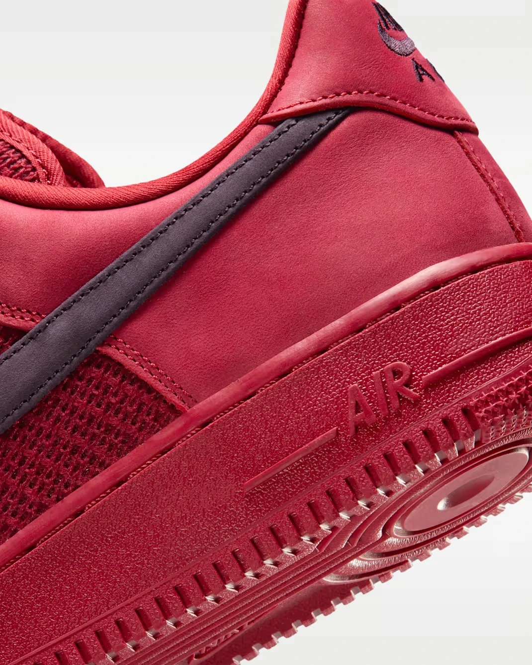 Close-up of the heel and Swoosh on the Nike Air Force 1 Low "Tough Red" sneaker.