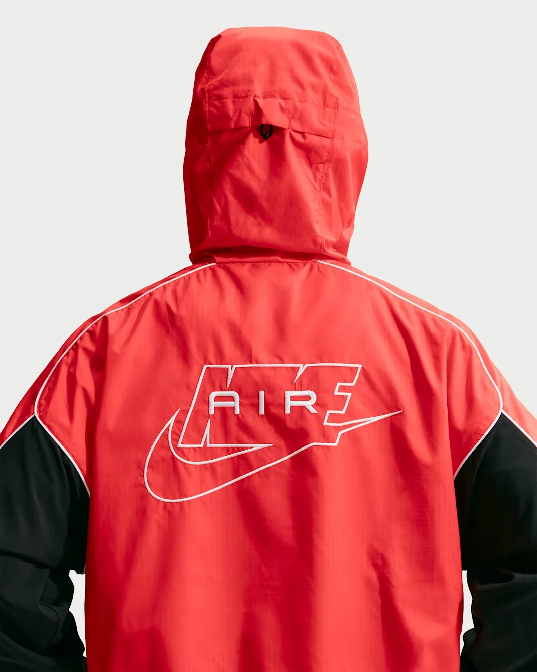 Back view of the Nike Air Hybrid Utility Jacket in Solar Red Black and White