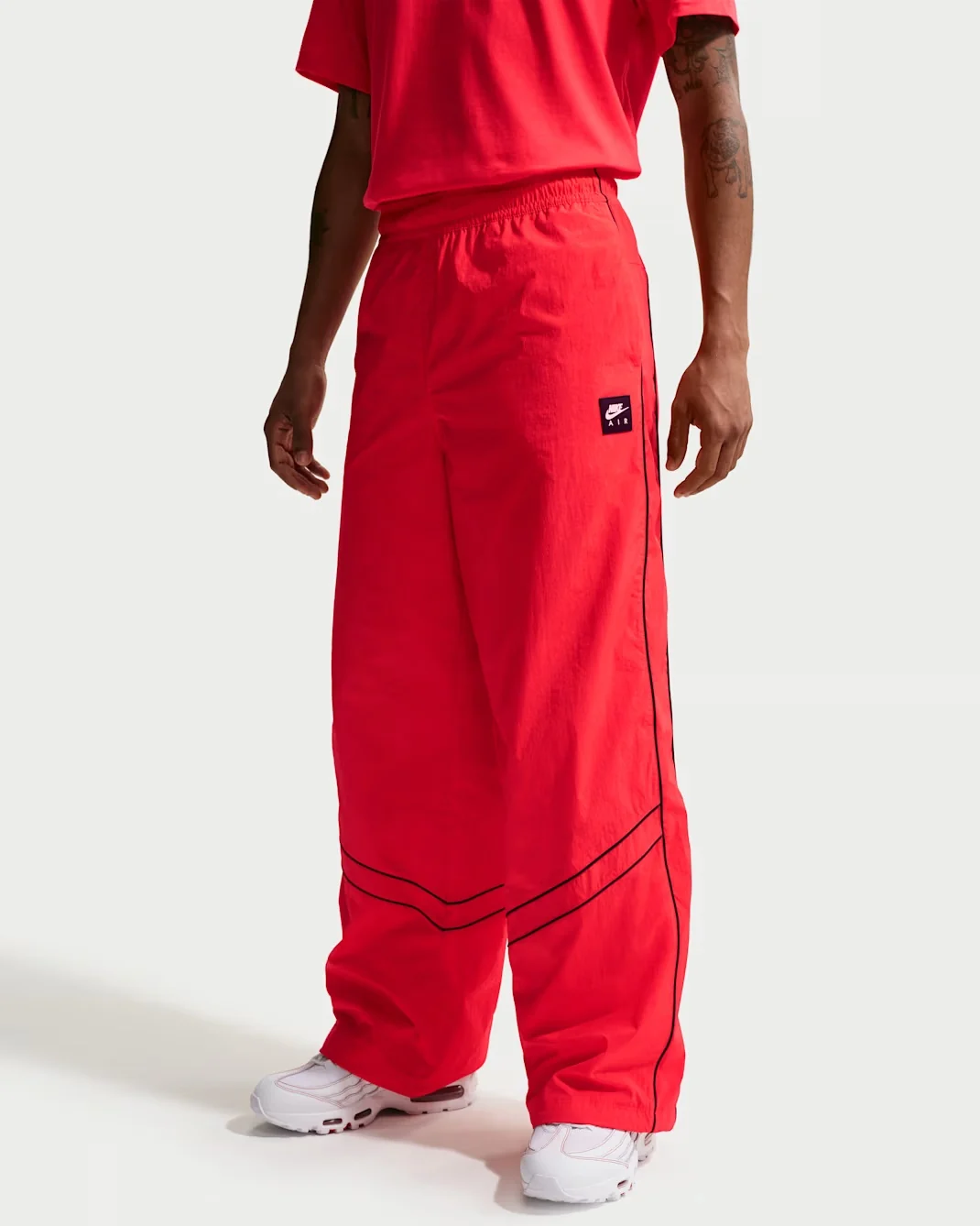 Nike Air Track Pants in Solar Red with Black piping