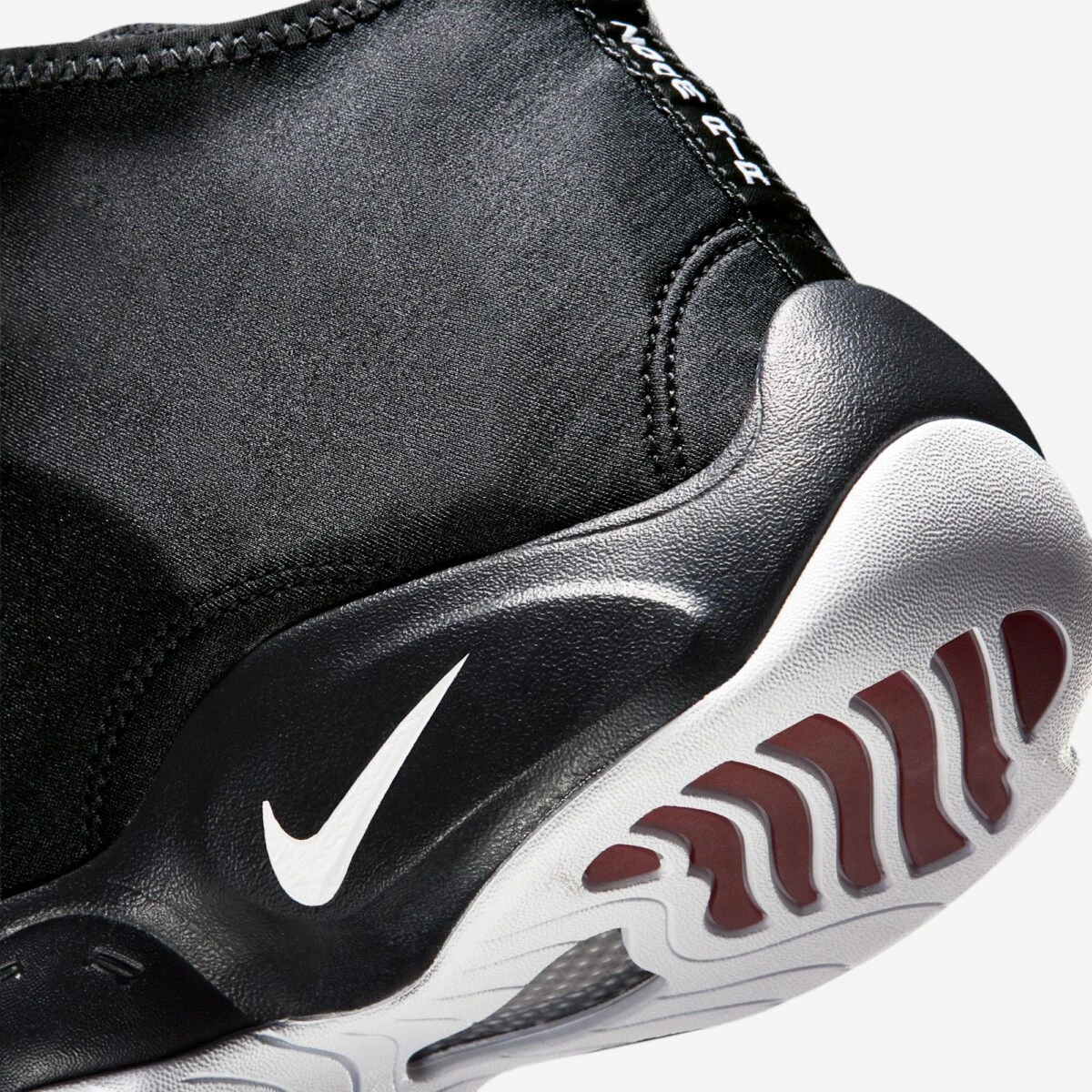 Close-up of the midsole and outsole on the Nike Air Zoom Flight "The Glove" in Black, White and University Red.