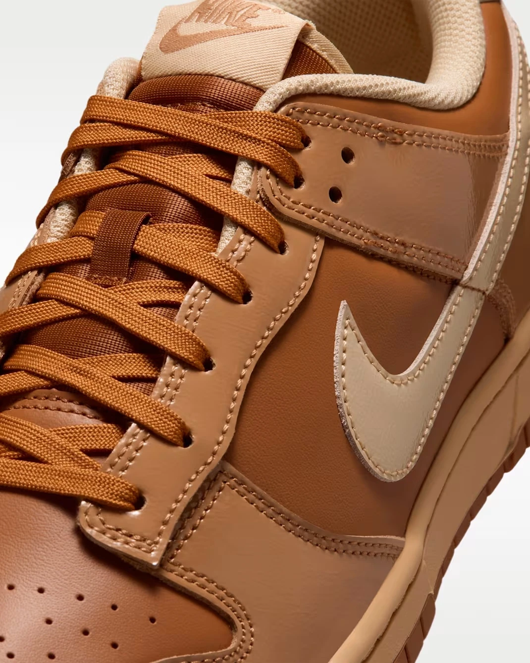 Close-up of the Nike Dunk Low "Wheat Donut" featuring the laces, leather panels and Flax Swoosh.