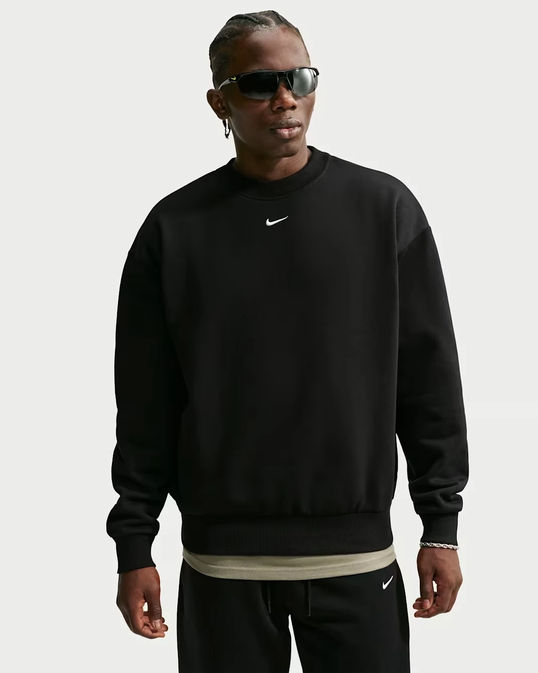 Nike Solo Fleece Men's Crew-Neck Sweatshirt in black with a white Swoosh logo.