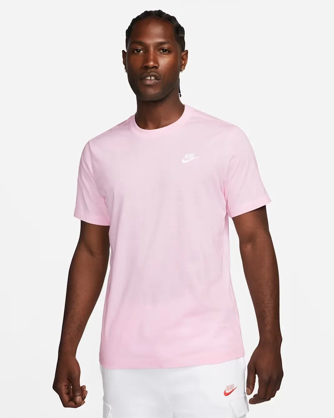 Model wearing the Nike Sportswear Club T-Shirt in Light Arctic Pink with a small white Nike logo on the chest.