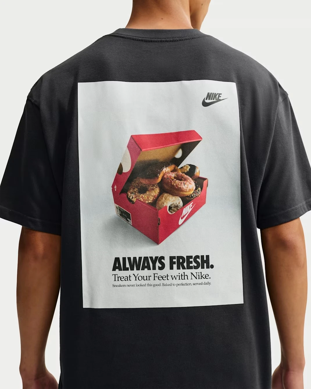 Back view of the Nike Sportswear "Donut" Men's T-Shirt in Off Noir featuring the "Always Fresh" donut box graphic.