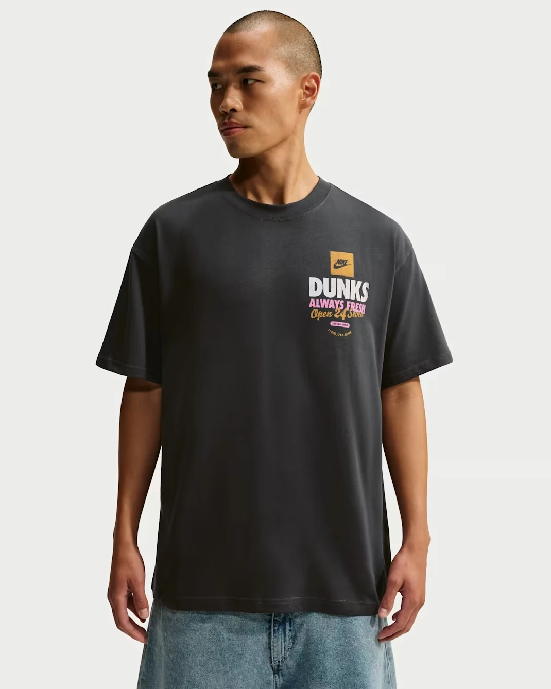 Front view of the Nike Sportswear "Donut" Men's T-Shirt in Off Noir featuring a "Dunks Always Fresh" chest graphic.