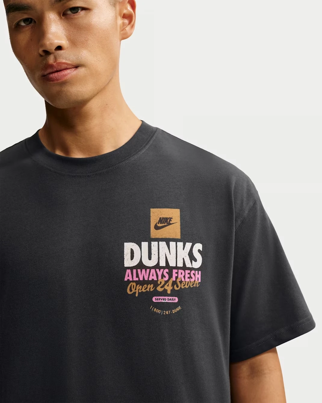 Close-up of the front "Dunks Always Fresh" graphic on the Nike Sportswear "Donut" T-Shirt in Off-Noir.