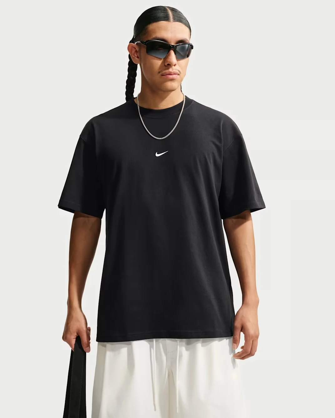 Nike Sportswear Men's Loose T-Shirt in black with a white Swoosh logo.