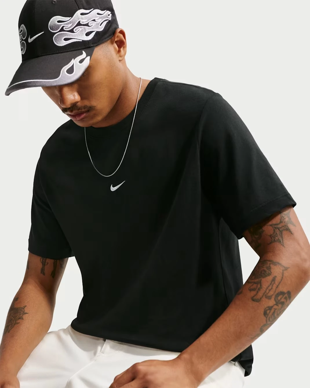 Nike Sportswear Men's T-Shirt in black with a white Swoosh logo.