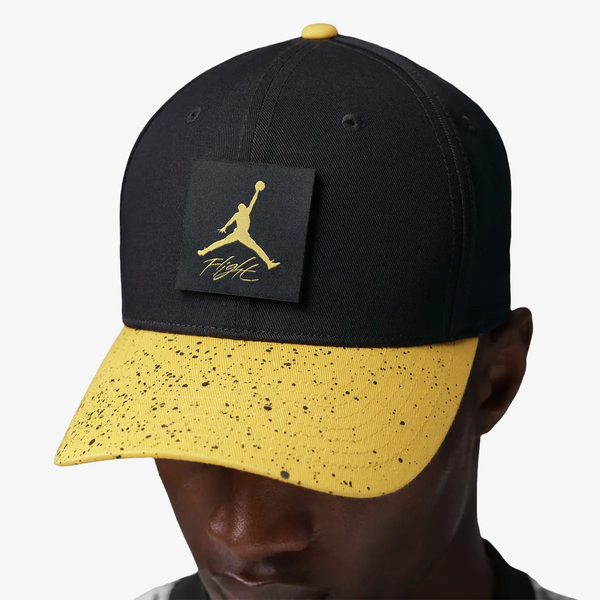 Jordan Rise Cap snapback hat in black and Tour Yellow with Jumpman Flight patch and speckled yellow brim