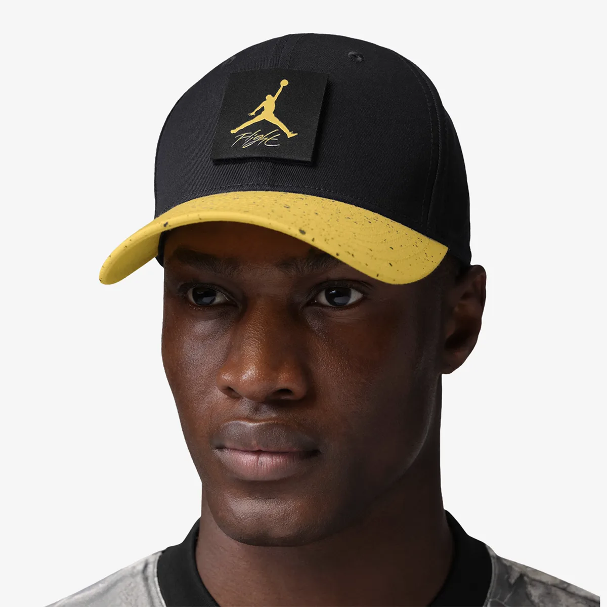 Front view of Jordan Rise Cap snapback hat in black and Tour Yellow with Jumpman Flight patch
