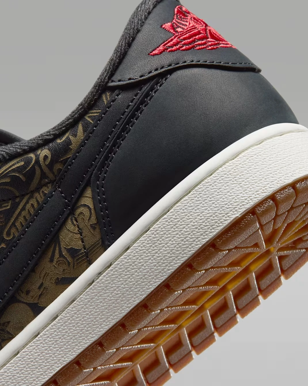Close-up of the Air Jordan 1 Low OG Laser heel with Varsity Red Wings logo, Summit White midsole and gum outsole.