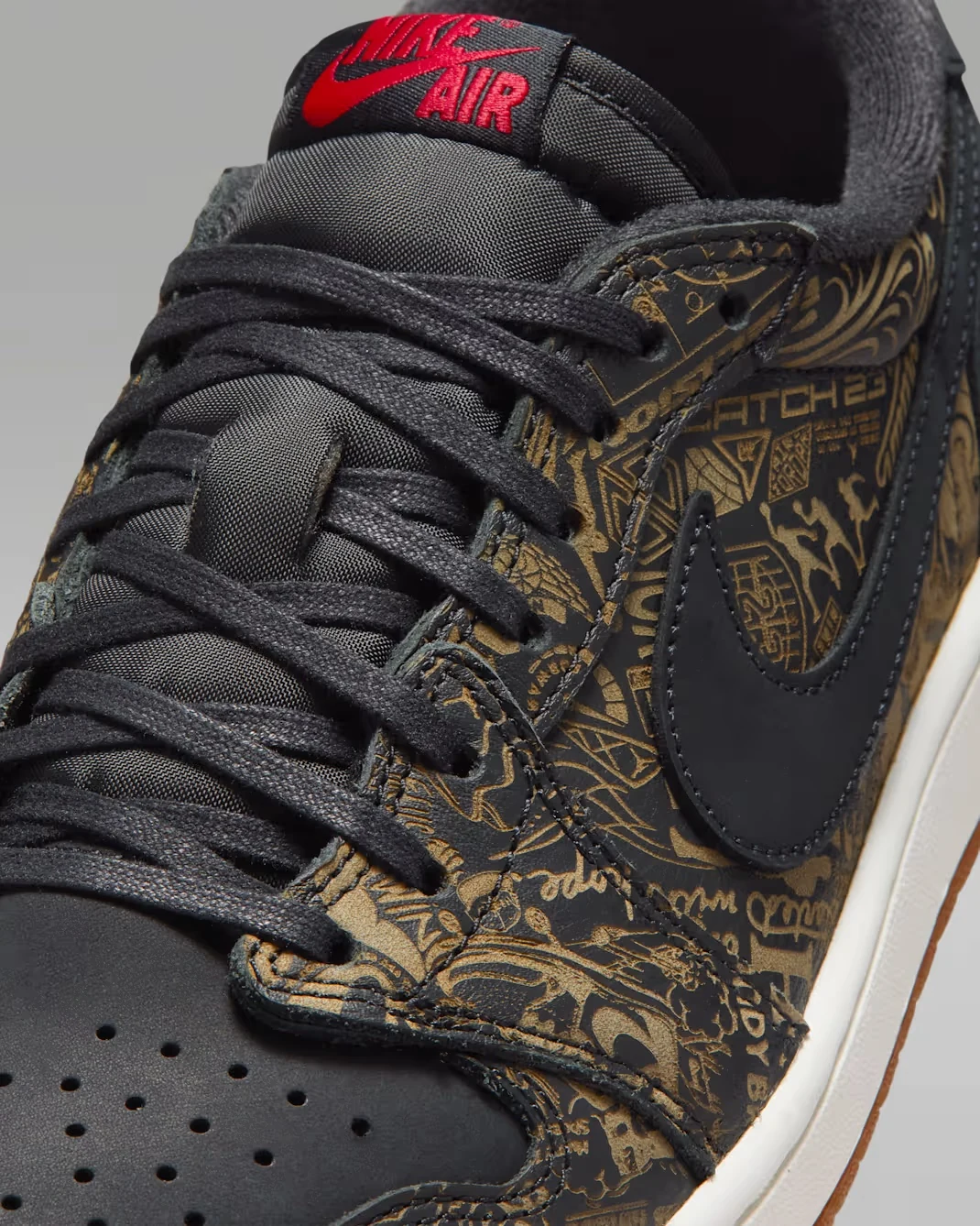 Close-up of the Air Jordan 1 Low OG Laser showing laser-etched upper graphics, black Swoosh and red Nike Air branding.