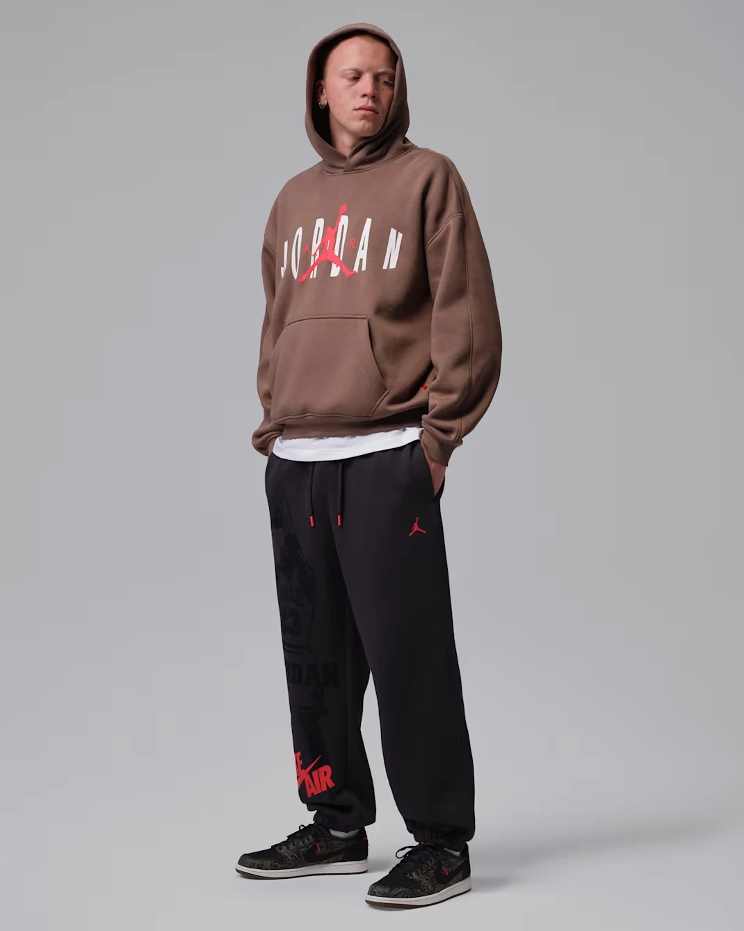Air Jordan 1 Low OG Laser sneakers styled with a Jordan hoodie and black Jordan pants.