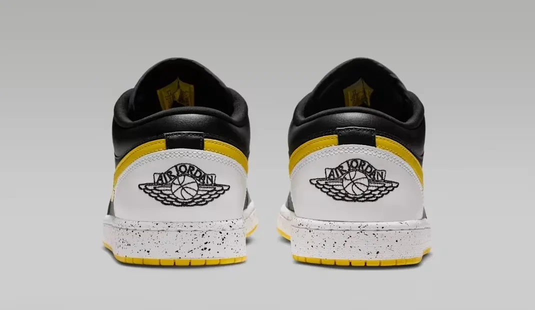 Rear view of the Air Jordan 1 Low Tour Yellow showing white heels with black Wings logos and yellow accents.