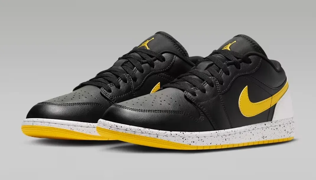 Pair of Air Jordan 1 Low Tour Yellow sneakers in Black, White and Tour Yellow.