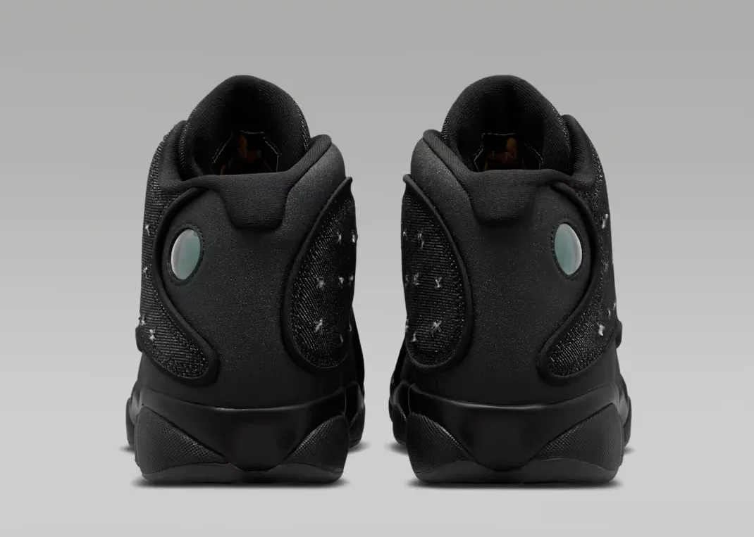 Rear heel view of the Air Jordan 13 Retro Wings showing holographic cat eye logos.