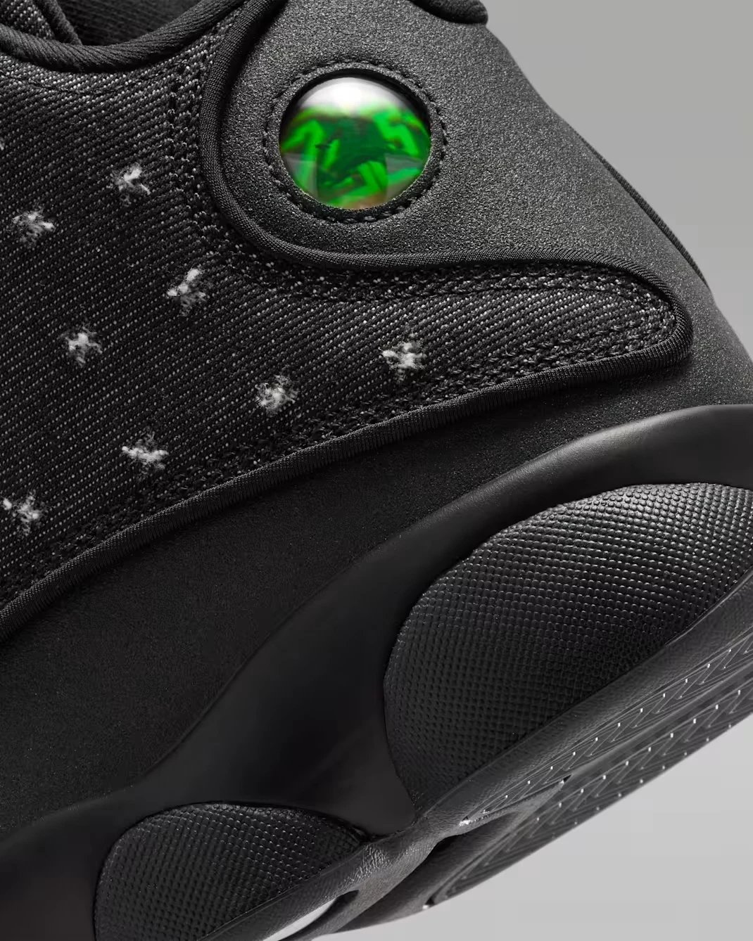 Close-up of the holographic cat eye logo on the Air Jordan 13 Retro Wings.