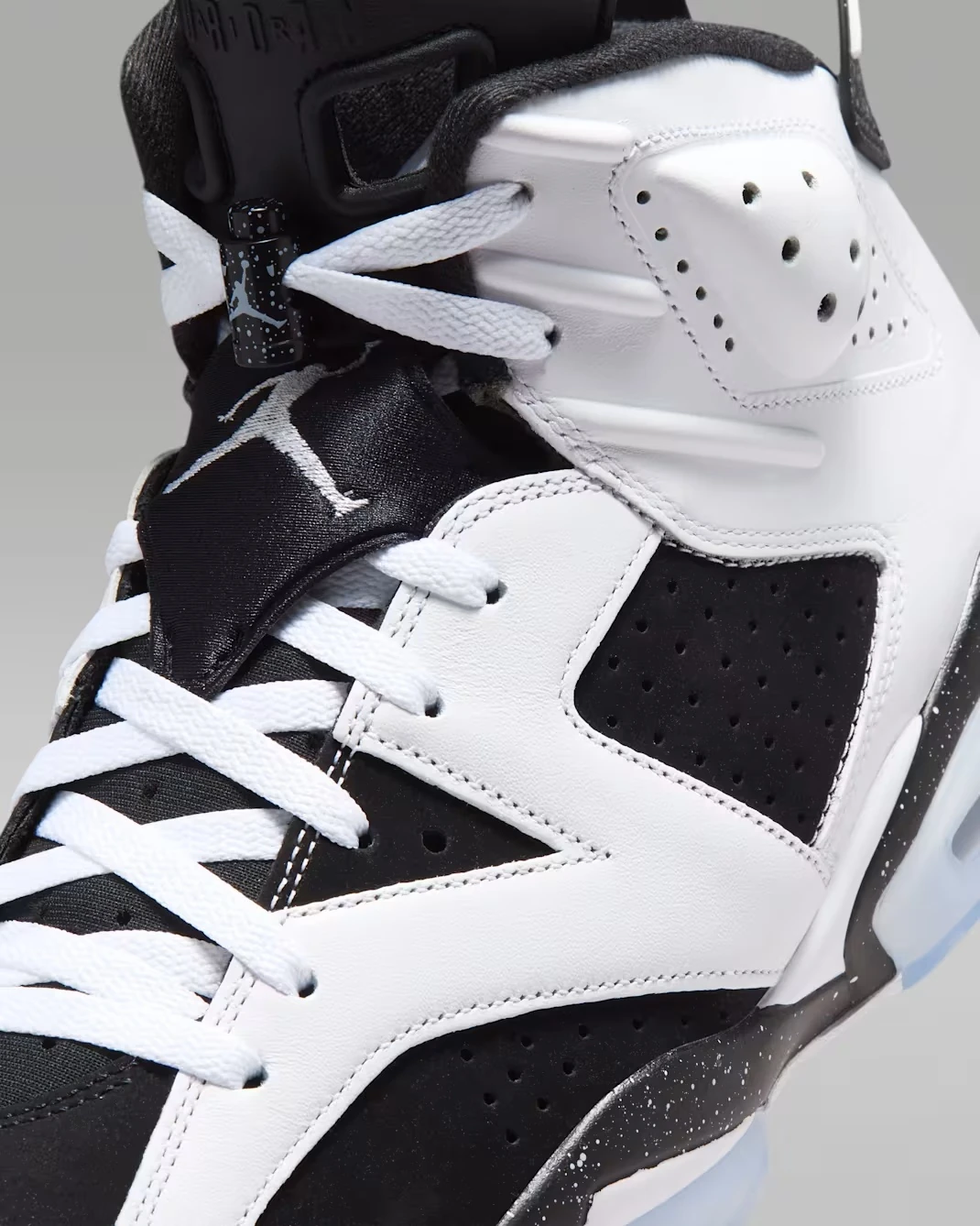 Close-up of the Air Jordan 6 Oreo 2026 tongue, lace lock, and White Black upper.