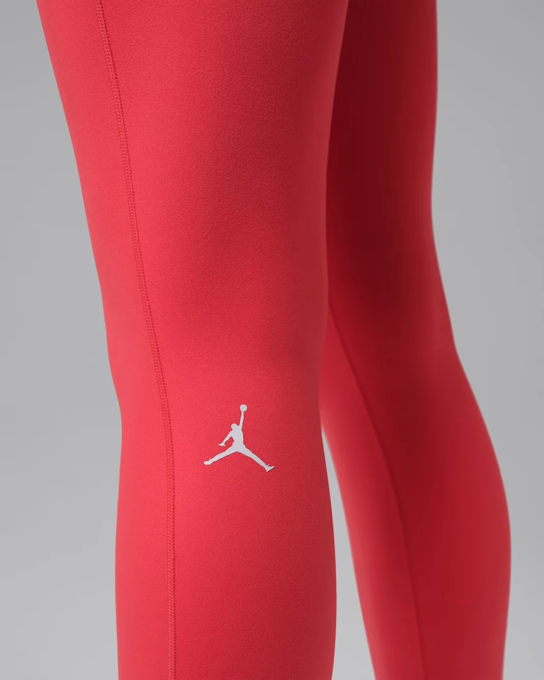 Detail of Air Jordan Women’s Sport Dri-FIT Practice High-Rise Tights in Track Red with Jumpman logo