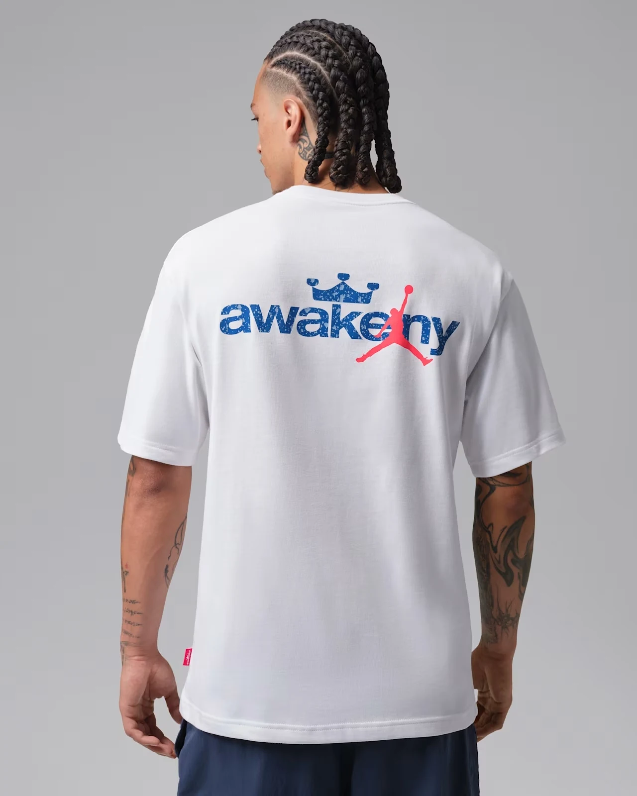 Back view of Jordan x Awake NY white T-shirt with Game Royal and Infrared 23 graphic.